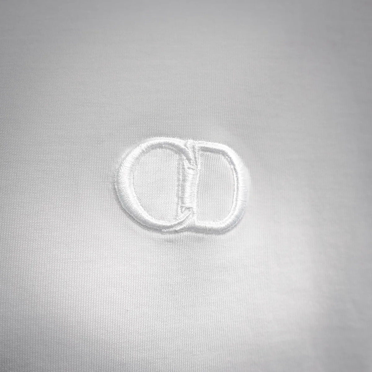 Dior logo embroidery patch on white T-shirt chest