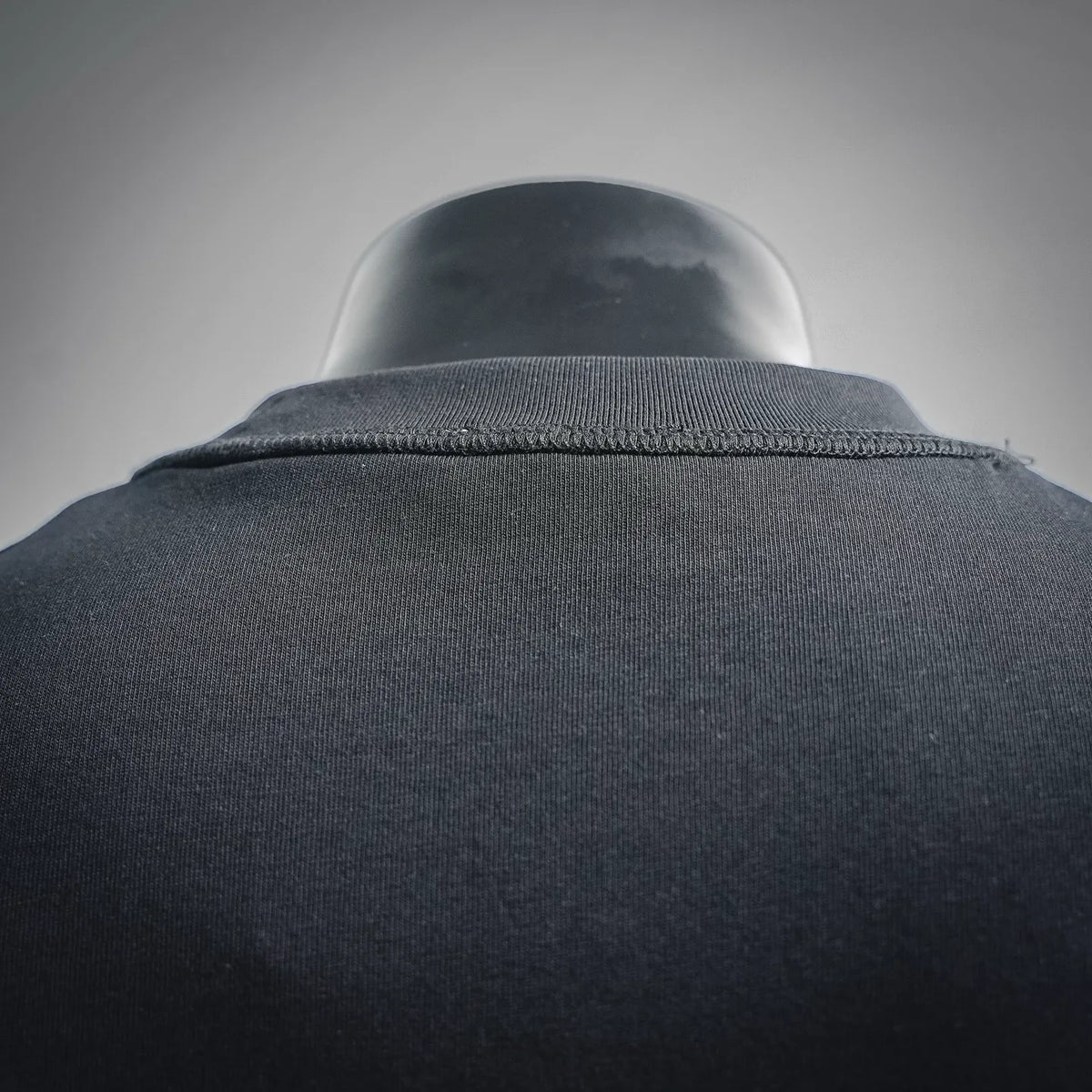 Black crewneck T-shirt collar ribbing close-up