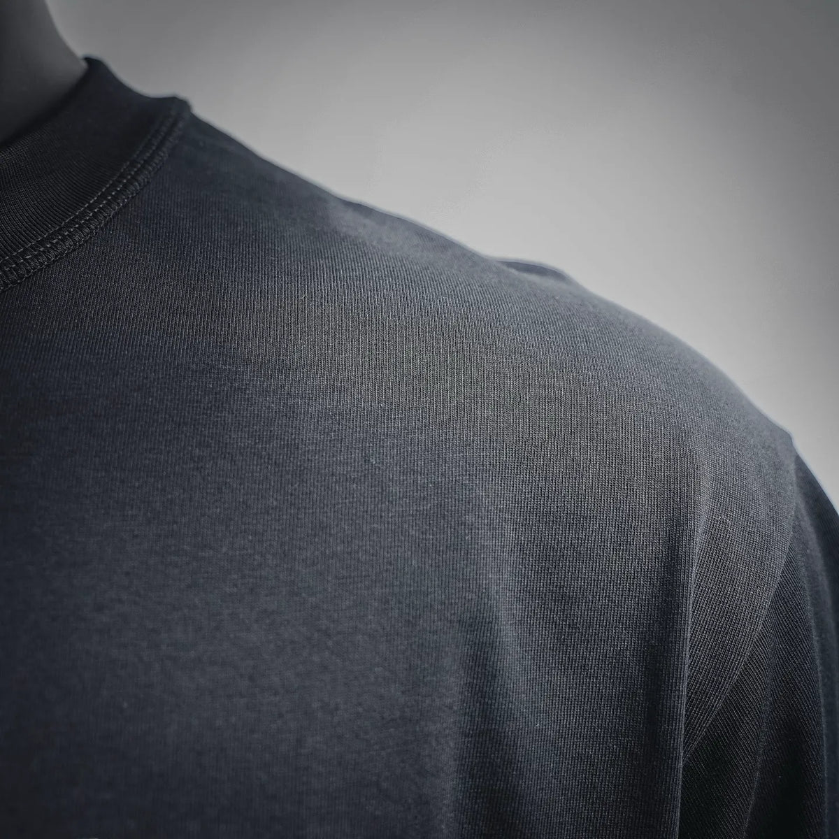 Black T-shirt shoulder seam and smooth knit fabric close-up
