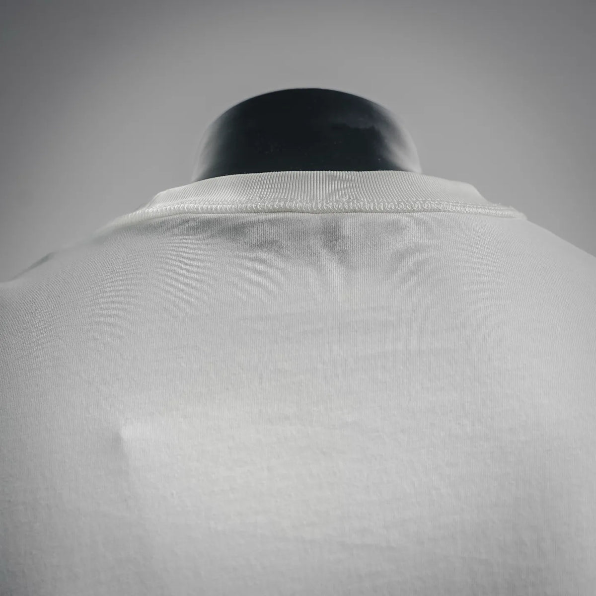 White crewneck T-shirt collar close-up with ribbed neckline