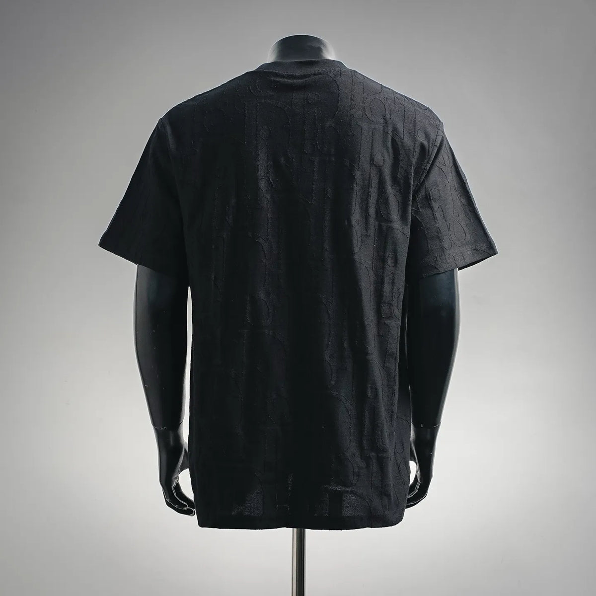 Black short-sleeve crewneck T-shirt with allover textured pattern, back view