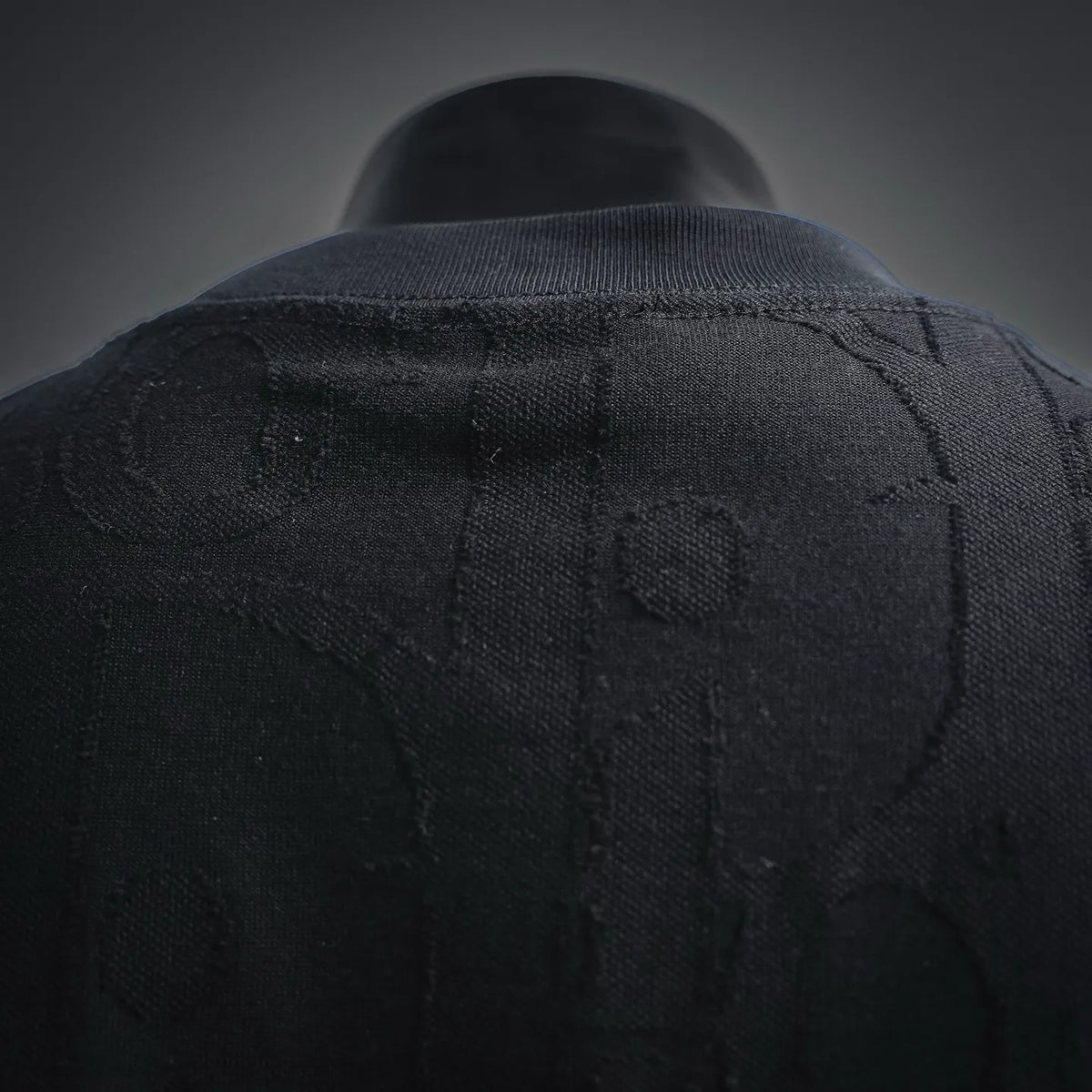Black short-sleeve T-shirt back close-up with textured pattern