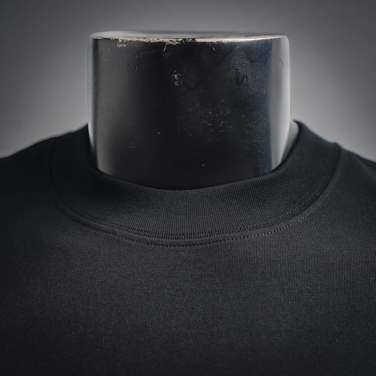 Black crewneck T-shirt with ribbed collar neckline close-up