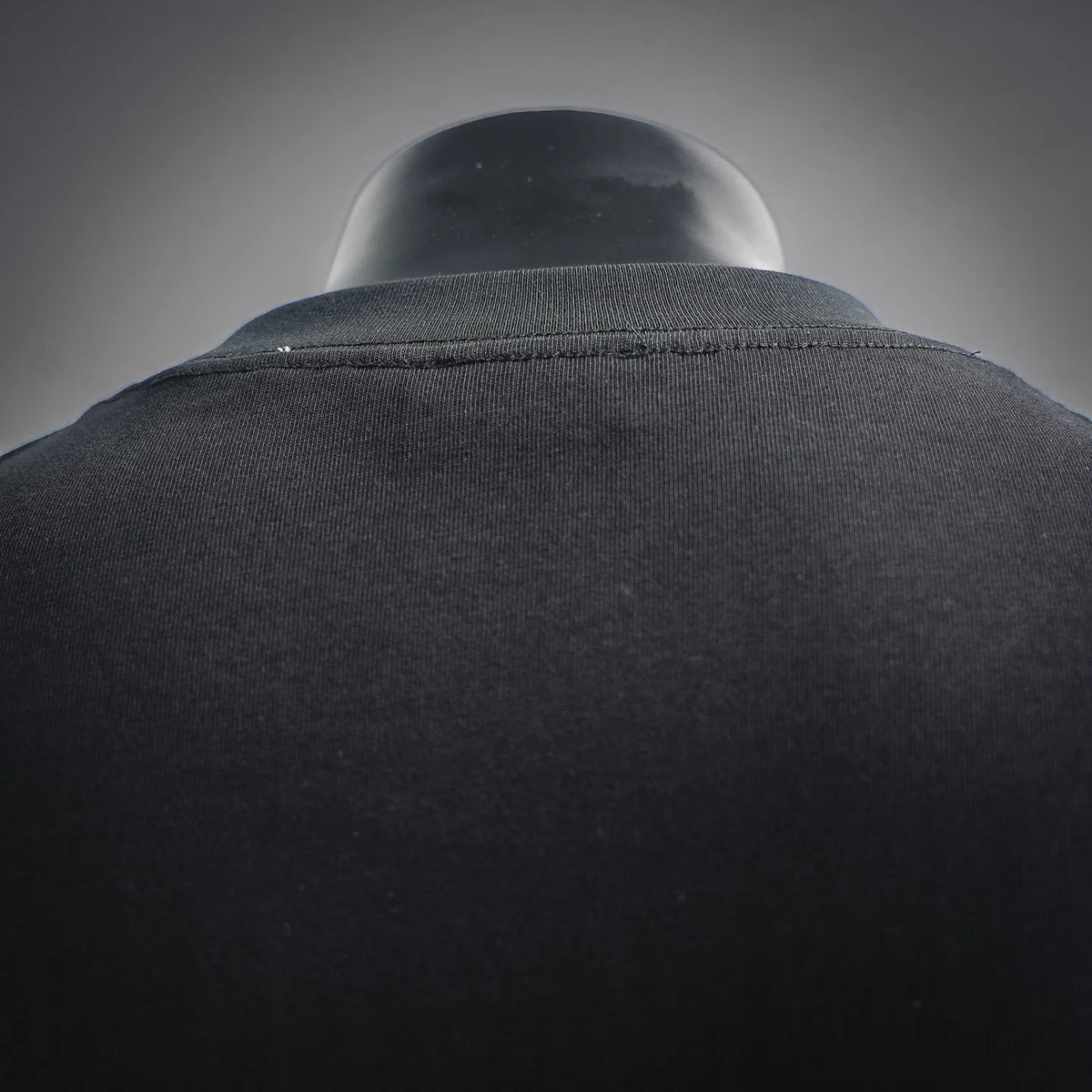 Black T-shirt shoulder seam and crewneck collar close-up