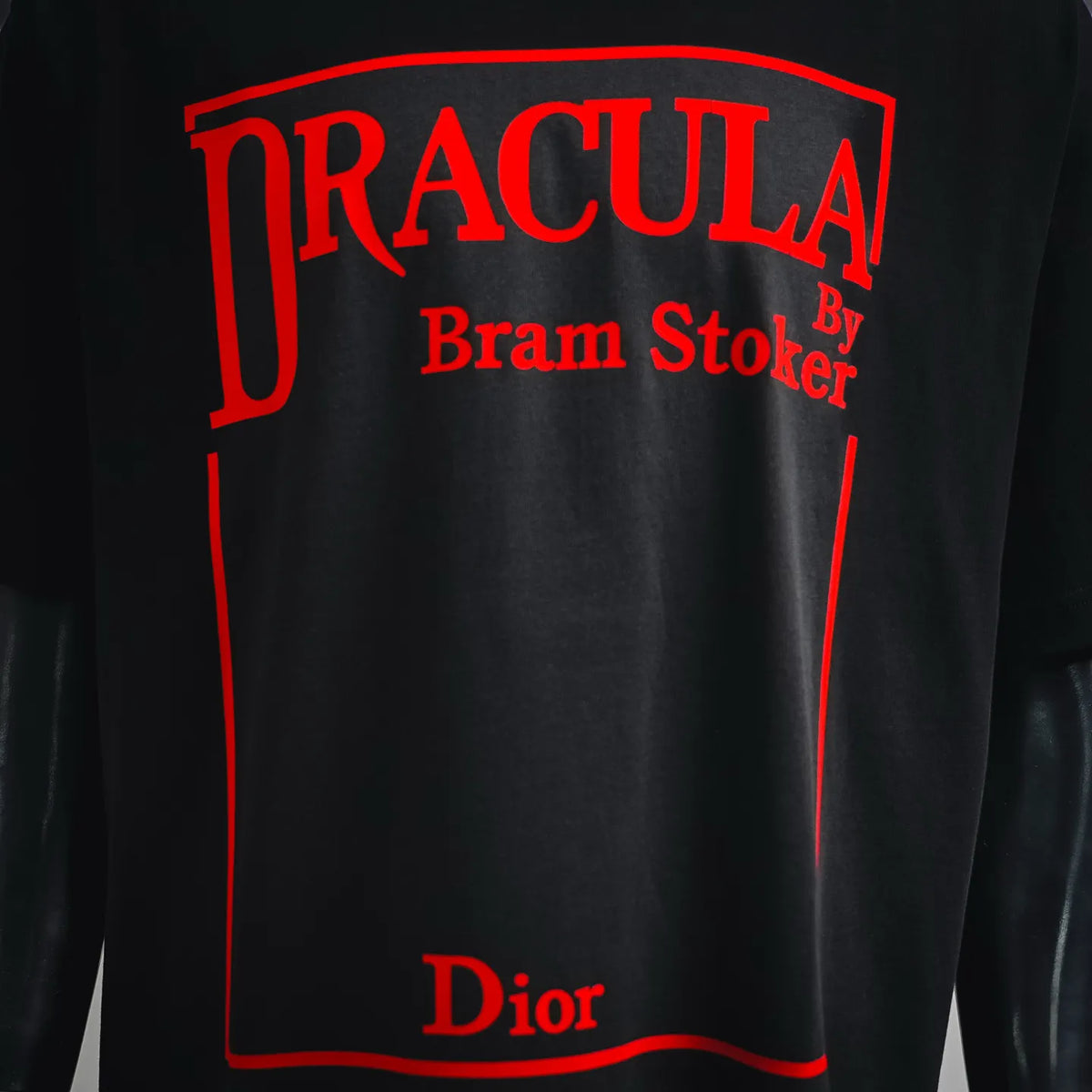 Black T-shirt front graphic with red 'TRACULA' text and 'Dior' label