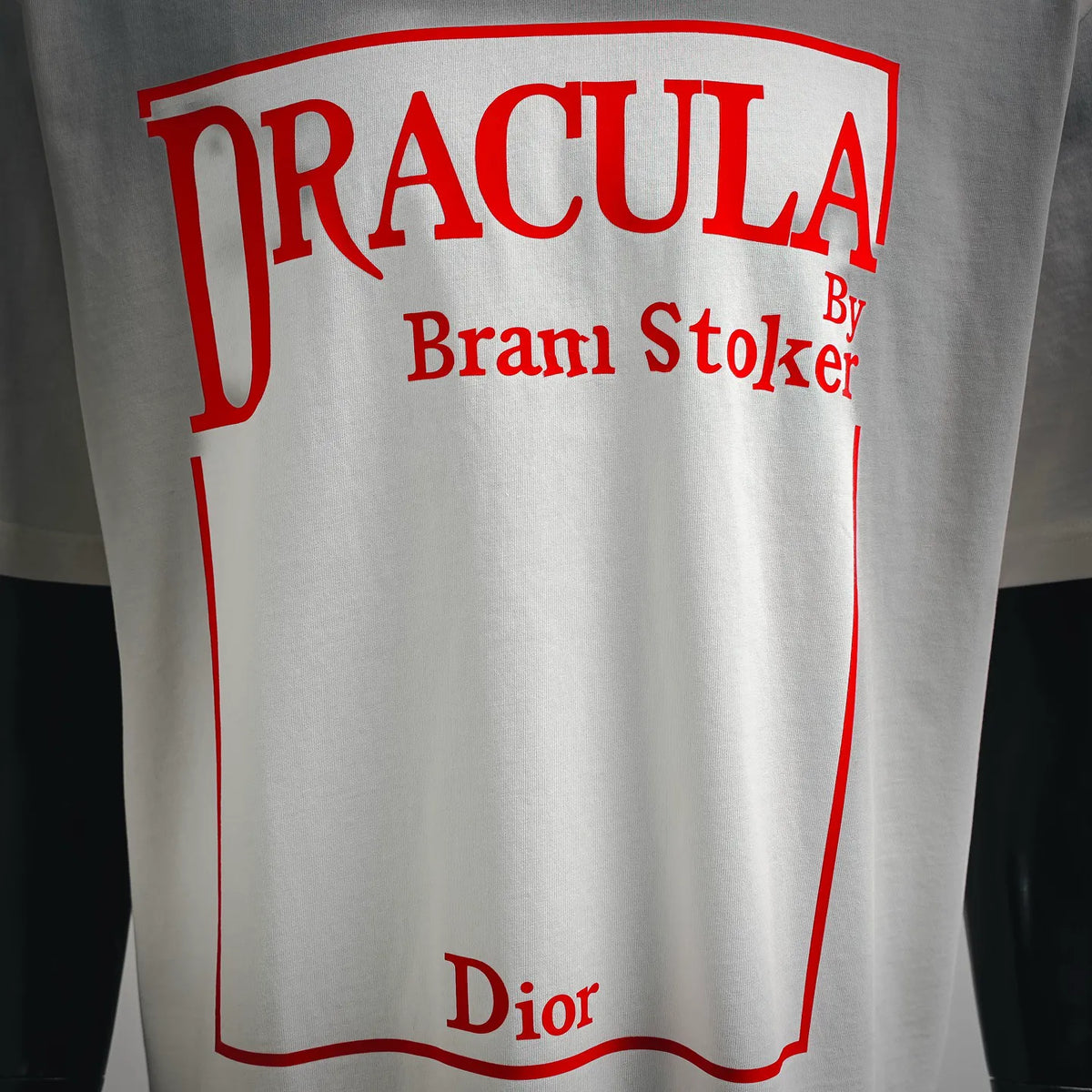 Close-up of white T-shirt front print: “DRACULA” with red “Brami Stoker” text