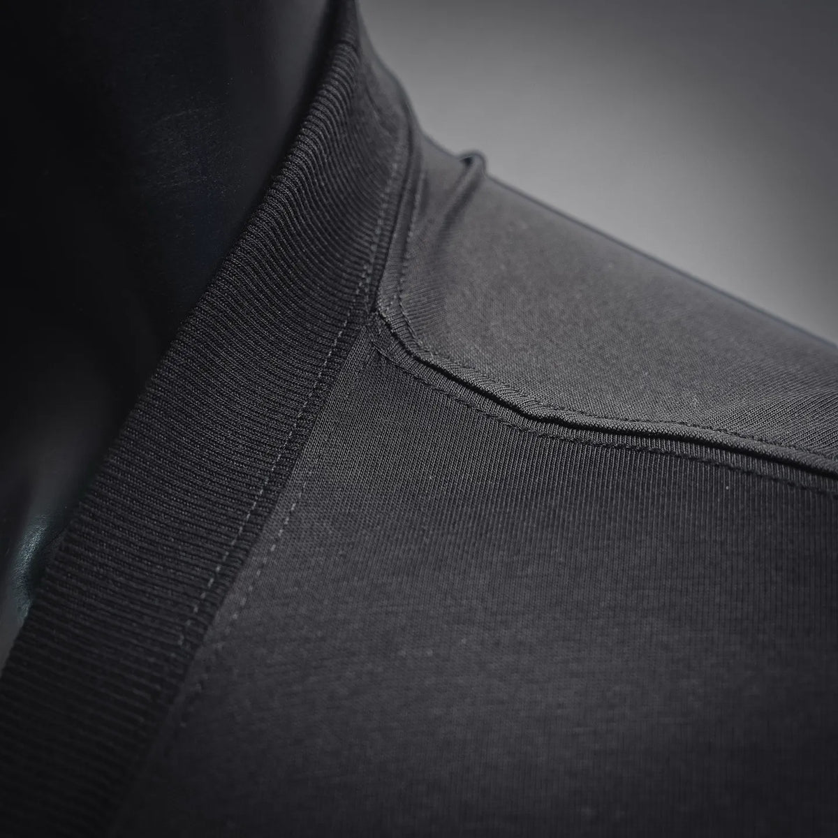 Black Dior T-shirt sleeve and hem close-up with ribbed cuff stitching