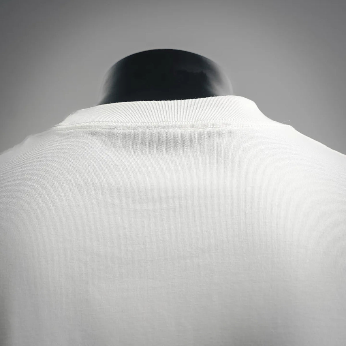 White crewneck T-shirt collar and back seam detail