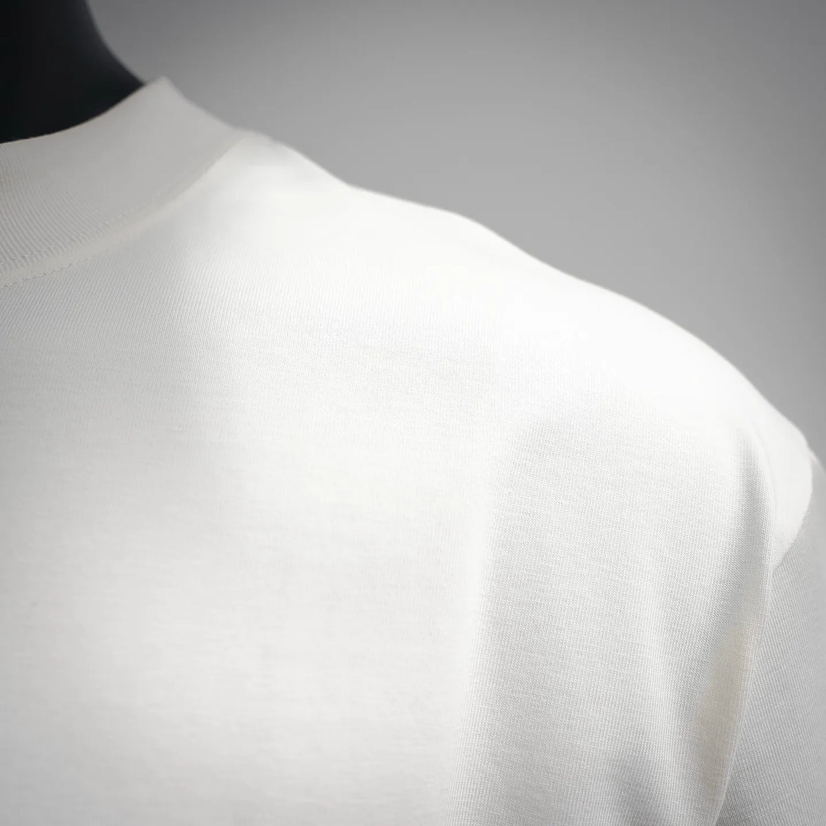 White crewneck T-shirt fabric close-up, shoulder area