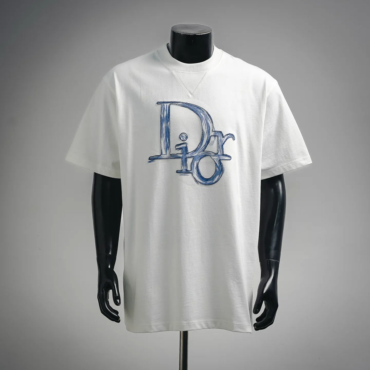 White short-sleeve T-shirt with blue 16 and D graphic on the chest.