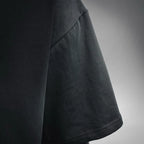 Black T-shirt sleeve corner with stitched hem detail