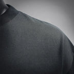 Black T-shirt shoulder area with fabric texture and seam stitching