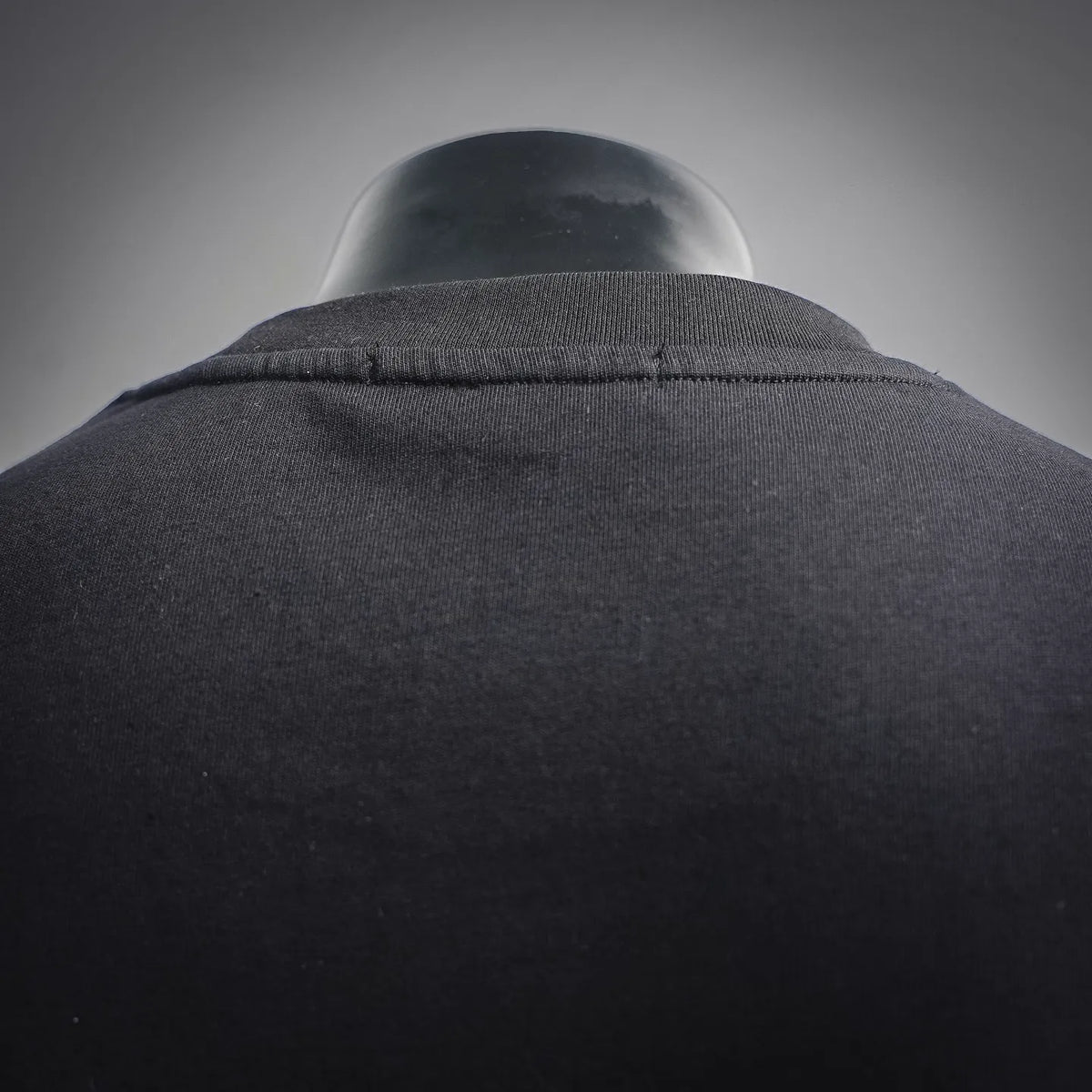Dior T-shirt close-up of crew neck and collar seam, dark charcoal