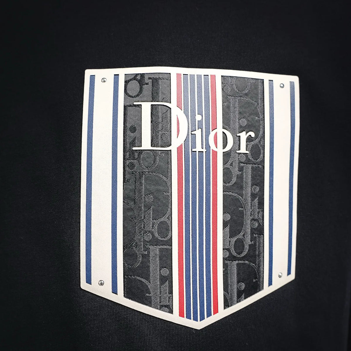 Dior chest logo graphic patch with striped pattern on dark charcoal T-shirt