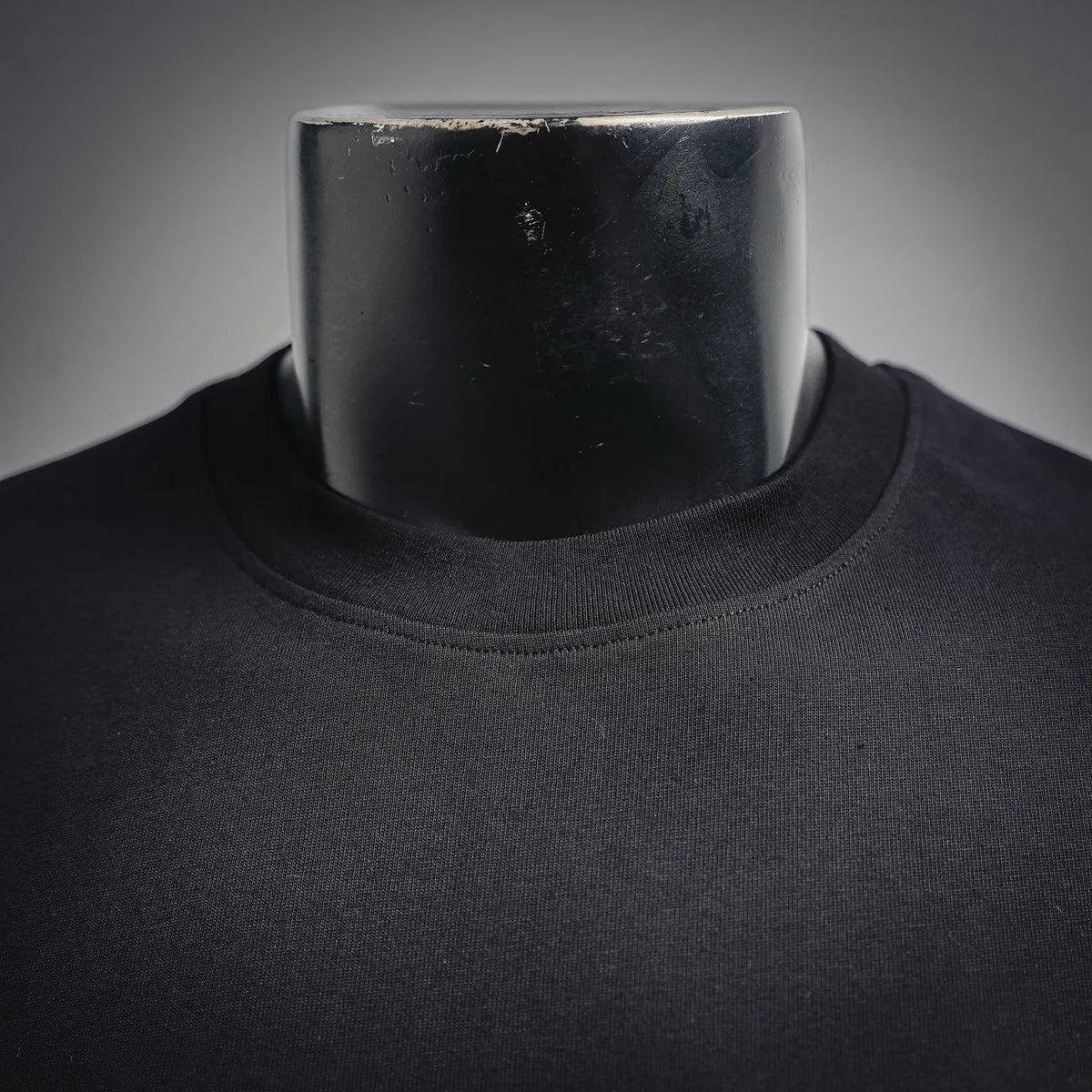 Dior crew neckline close-up in dark charcoal jersey knit