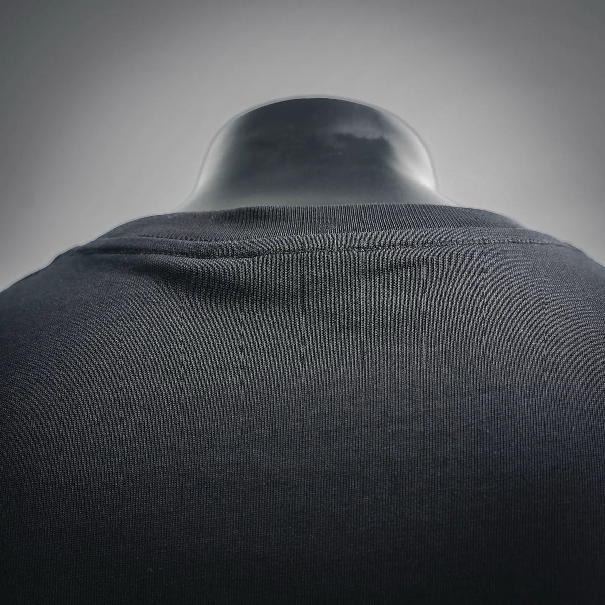 Men's T-shirt back close-up with ribbed collar and heathered fabric texture