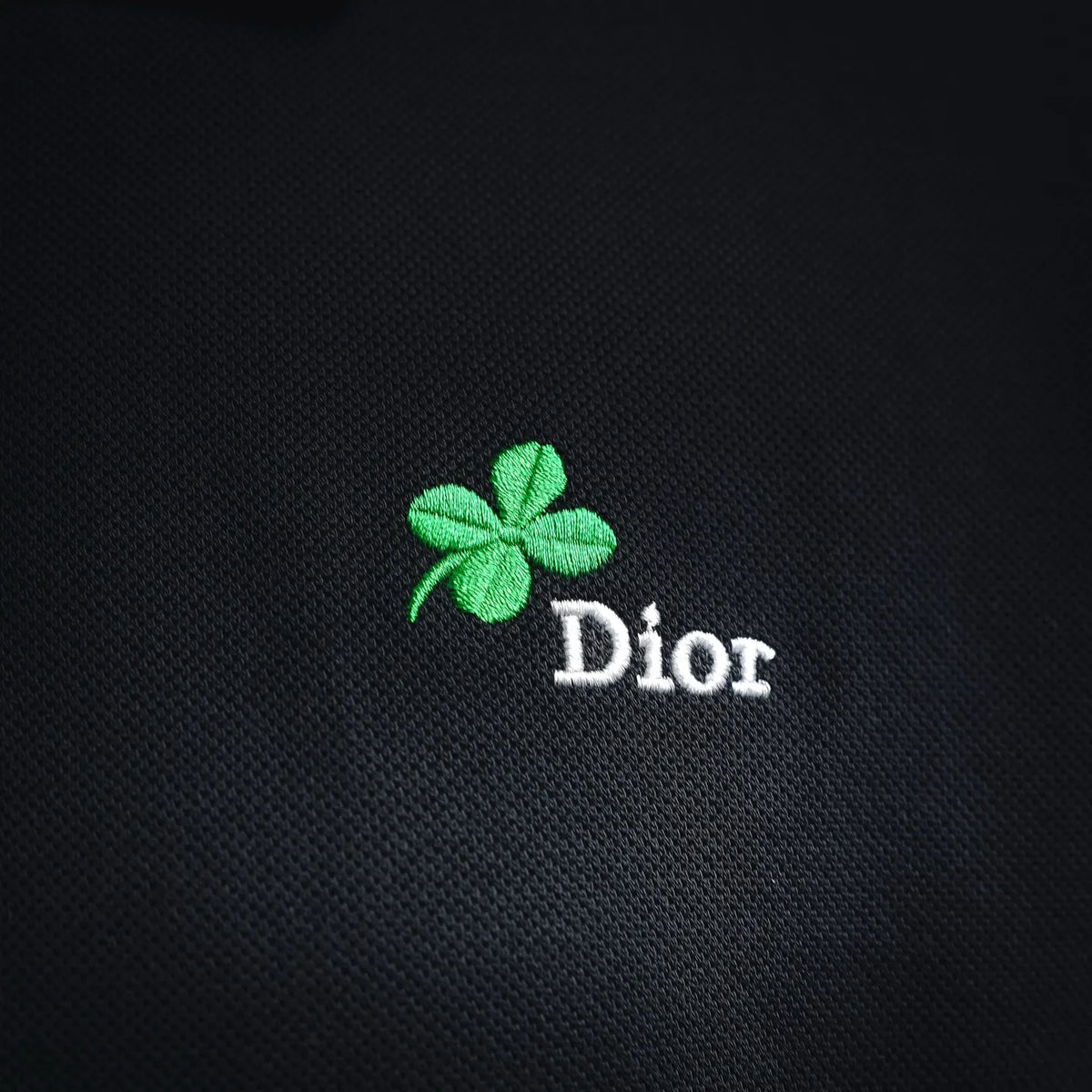 Dior polo shirt front logo: green clover emblem with 'Dior' lettering
