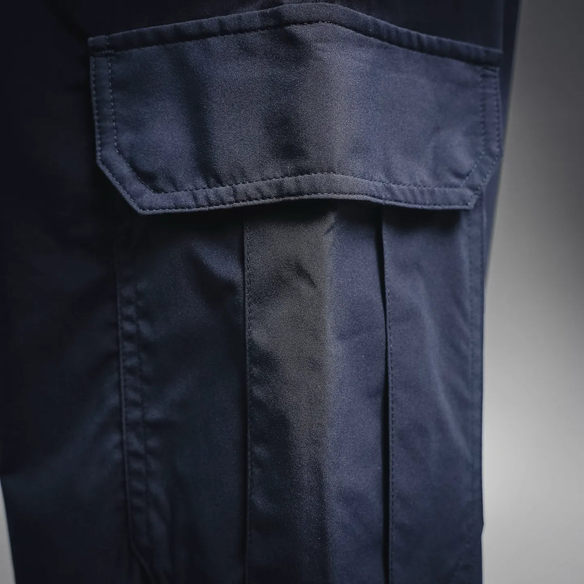 Navy cargo pocket with flap and stitched panel on pant leg