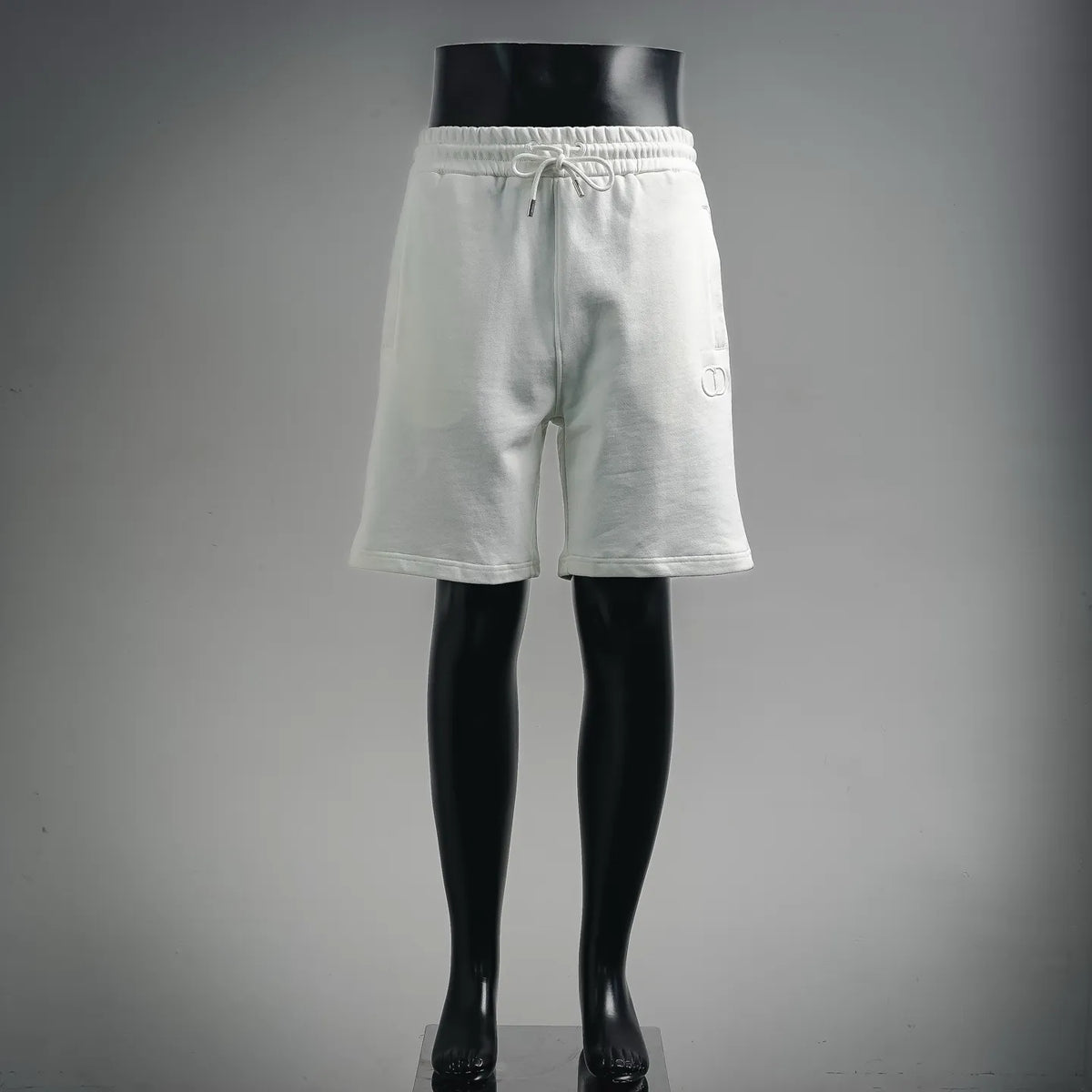 White drawstring shorts with elastic waist and side pockets