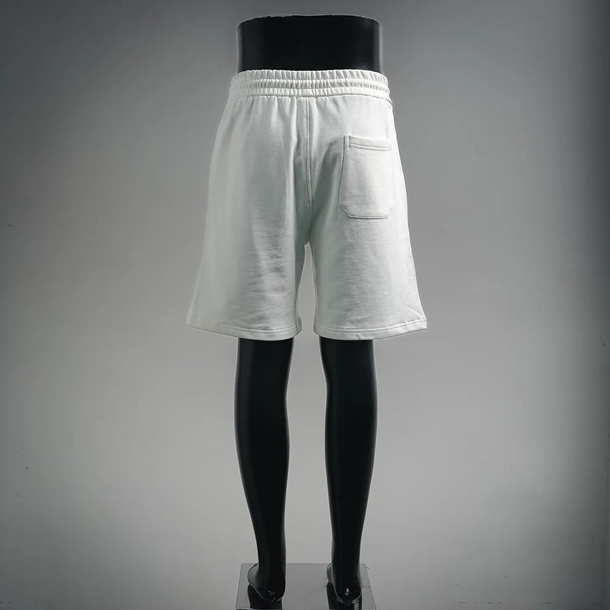 White drawstring shorts with elastic waist and back pocket detail