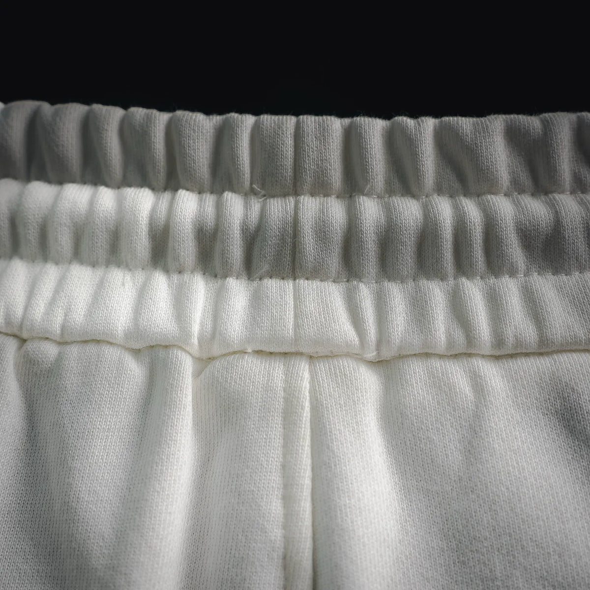 White elastic waistband with gathered ruffle trim and tie area