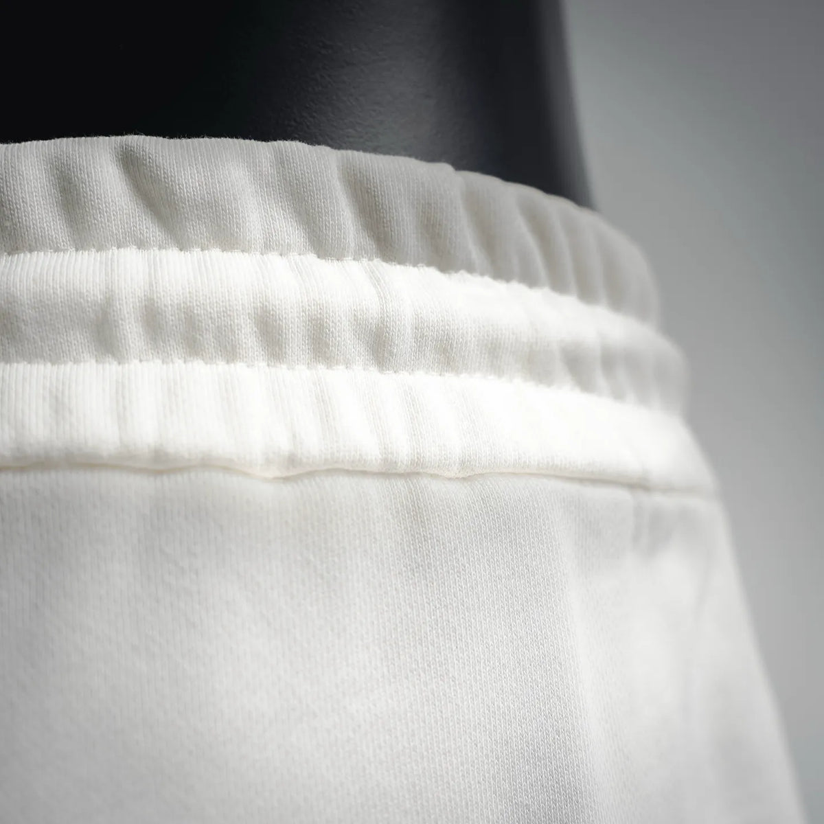 White shorts waistband with two drawstrings and metal aglets