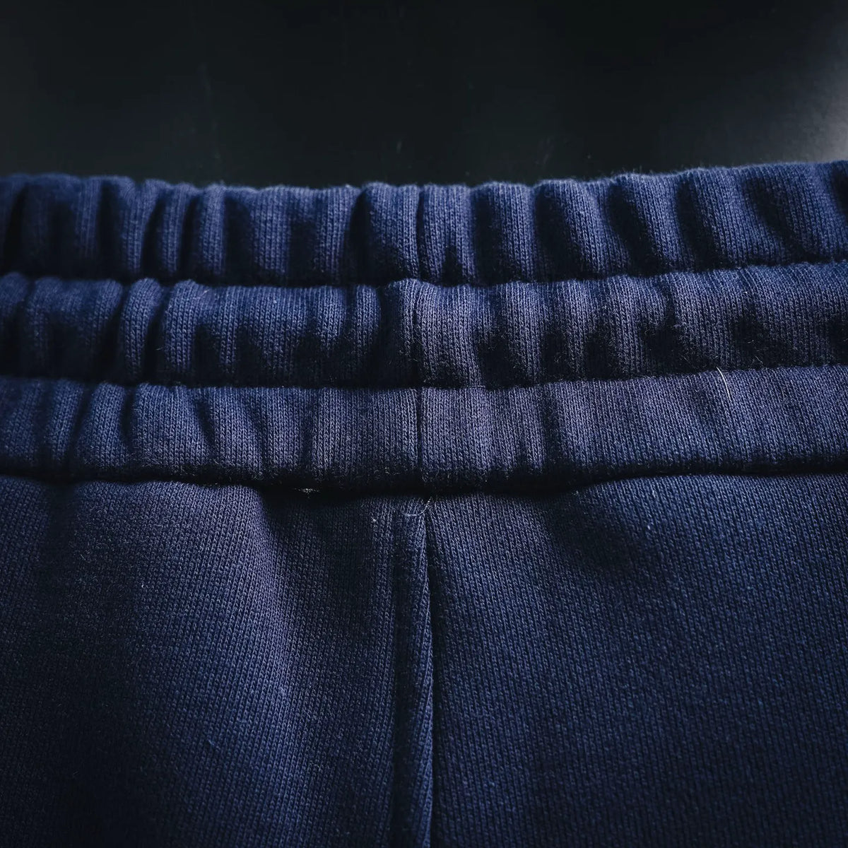 Navy knit waistband on Dior drawstring shorts with elastic channel detail