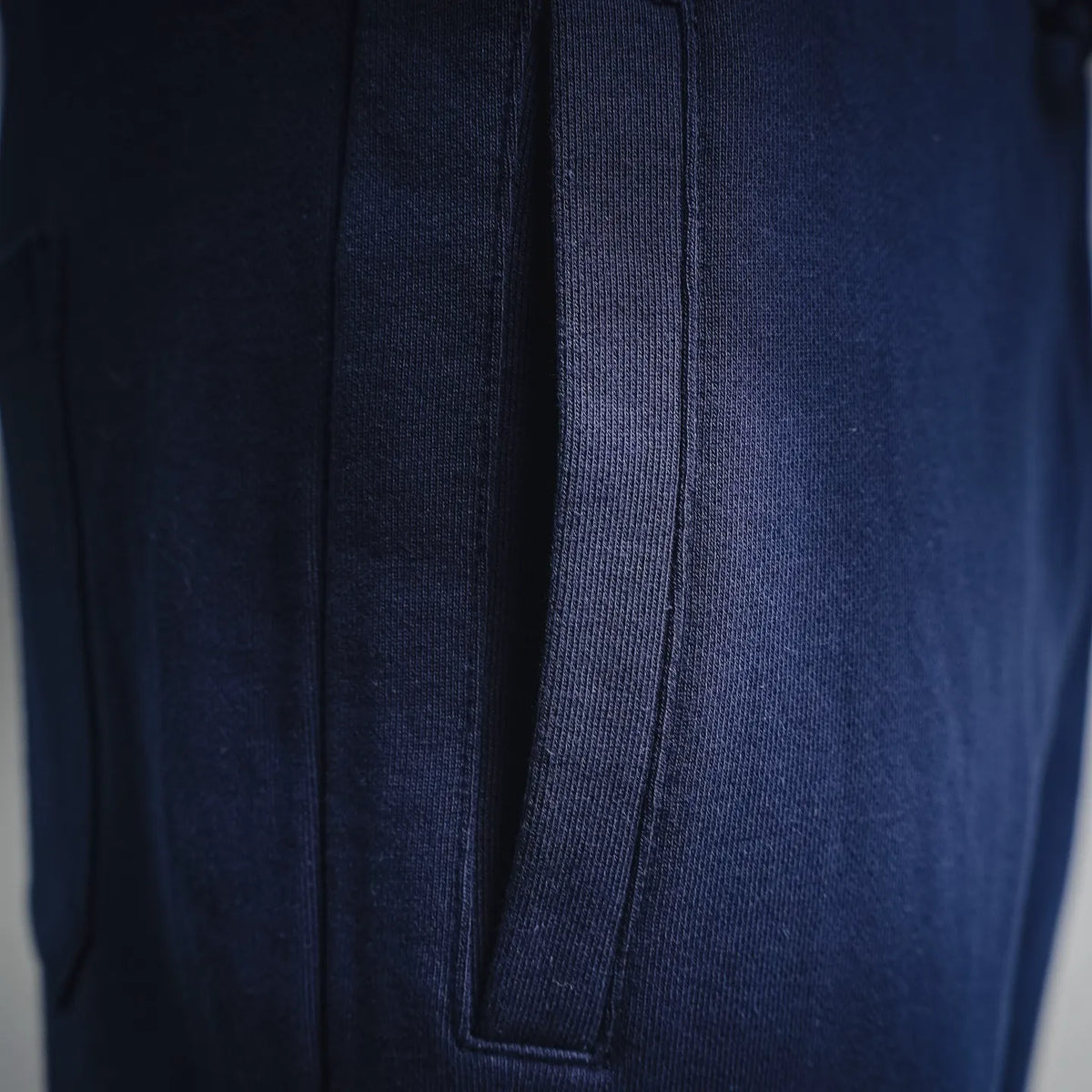 Navy Dior shorts side seam with vertical pocket opening and stitching