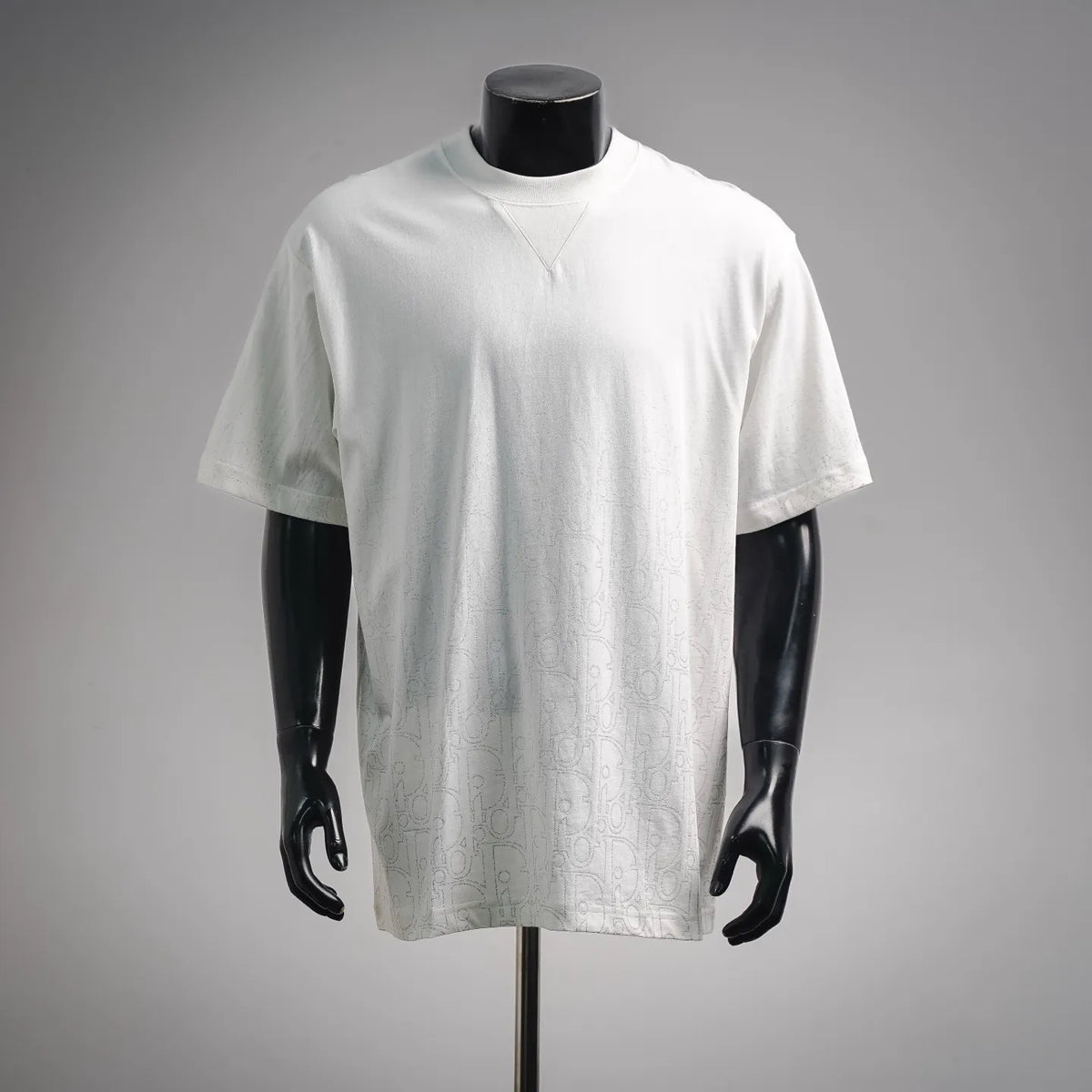 Dior white short-sleeve T-shirt on a mannequin, crew neckline with subtle pattern
