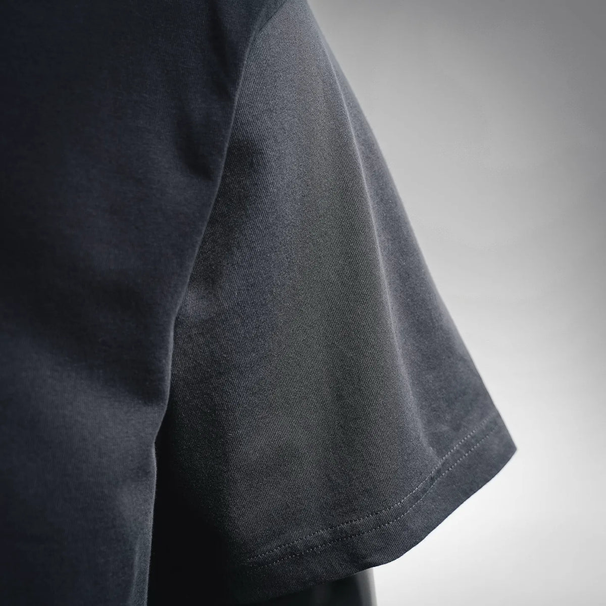 Dior short-sleeve T-shirt sleeve and side seam detail, dark fabric