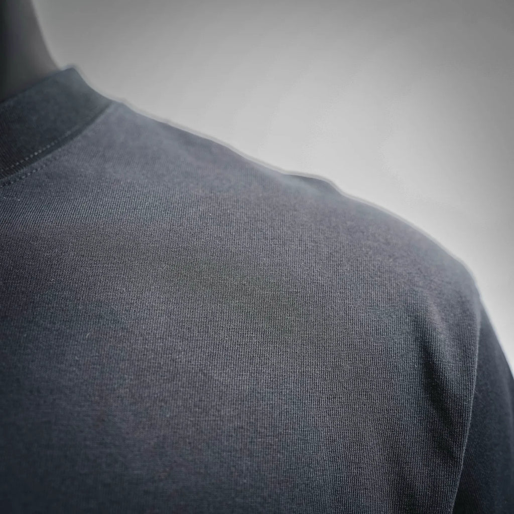 Dior short-sleeve T-shirt shoulder and sleeve close-up, dark knit texture
