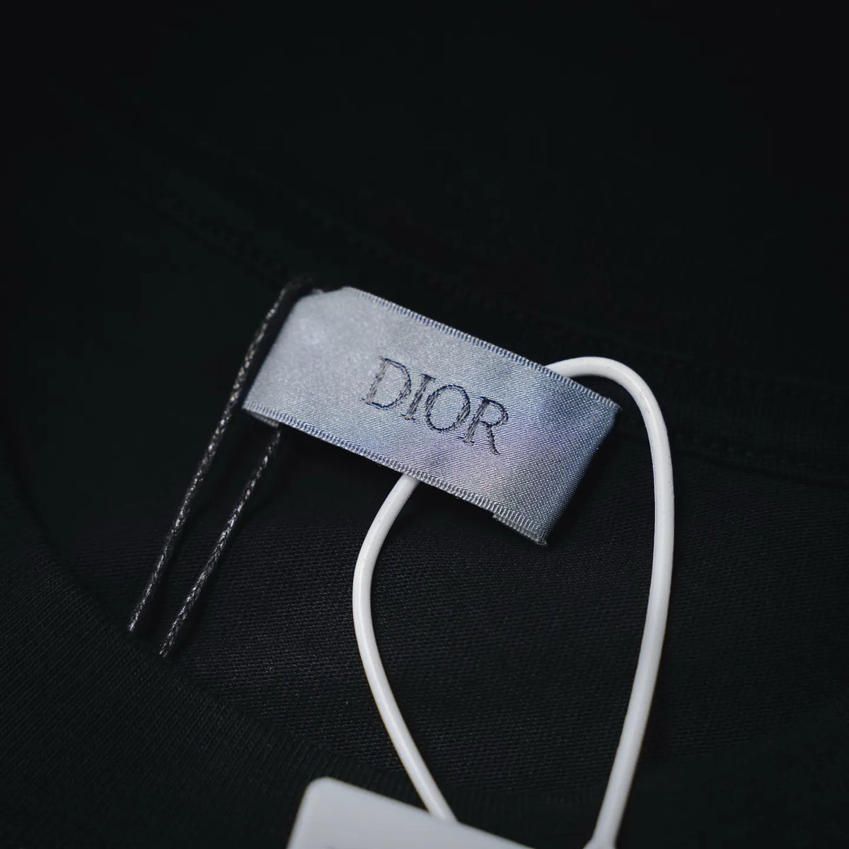 Dior T-shirt neck label close-up with white drawstring detail