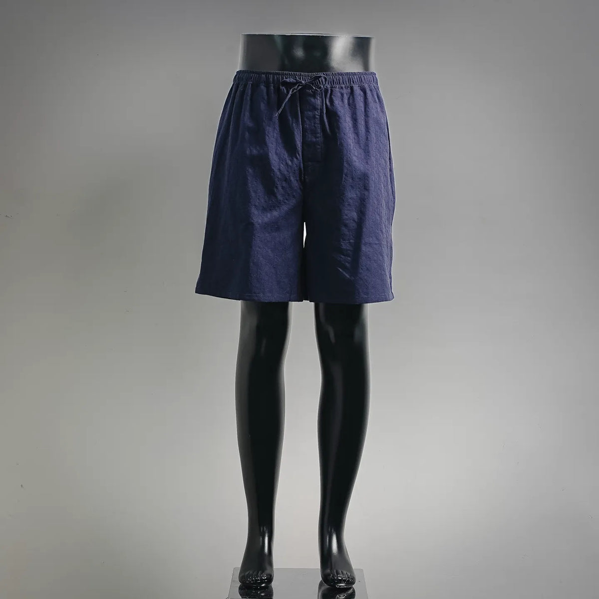 Navy drawstring shorts with elastic waistband and side pockets