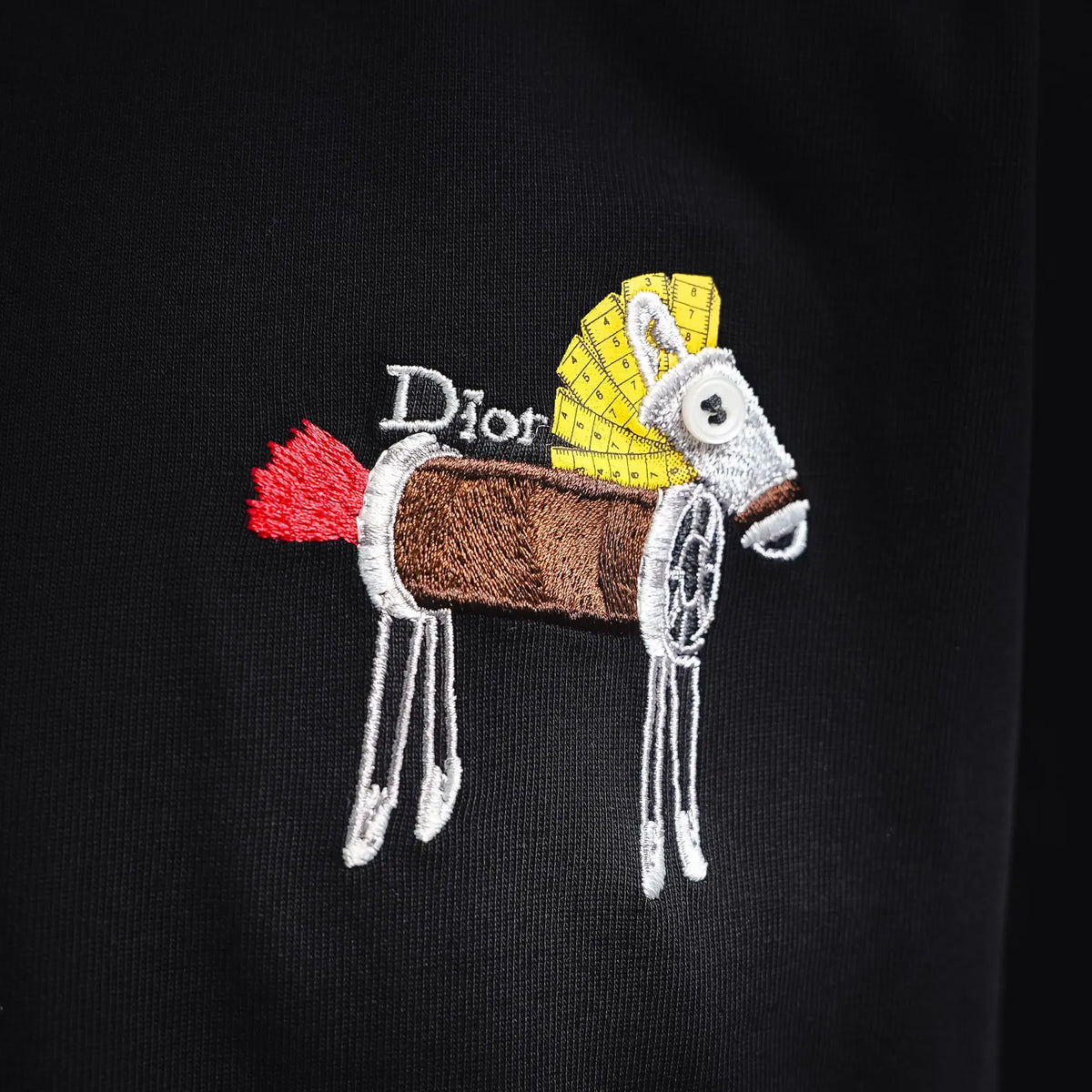 Colorful animal and cart embroidery with "Dior" text on black T-shirt