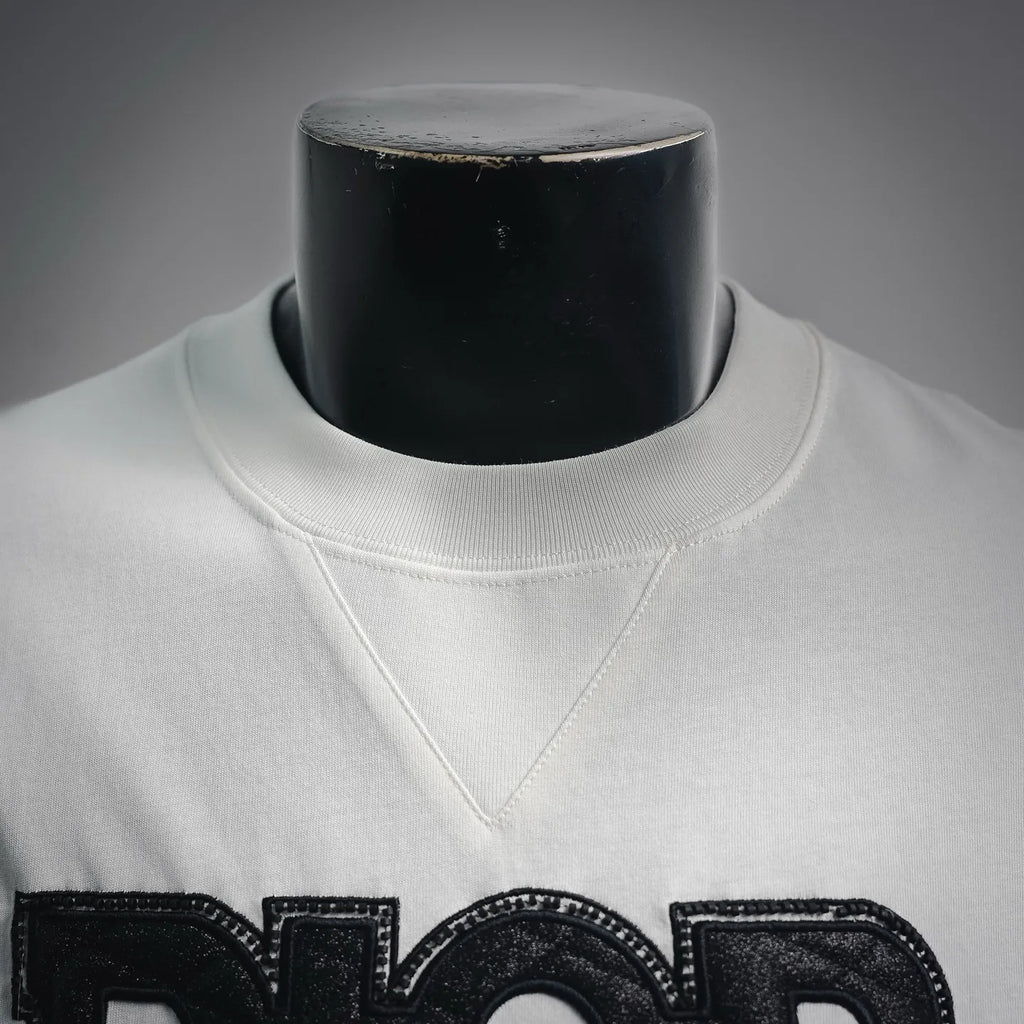 White Dior logo T-shirt neckline close-up with stitched collar and logo print