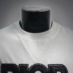 White Dior logo T-shirt neckline close-up with stitched collar and logo print
