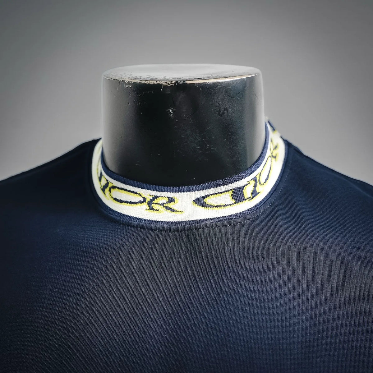 Dior T-shirt collar, yellow and white patterned logo trim on navy crew neck