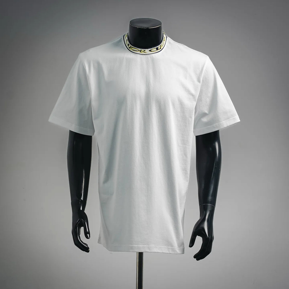 Dior white short-sleeve T-shirt on mannequin with crew neck and striped collar trim
