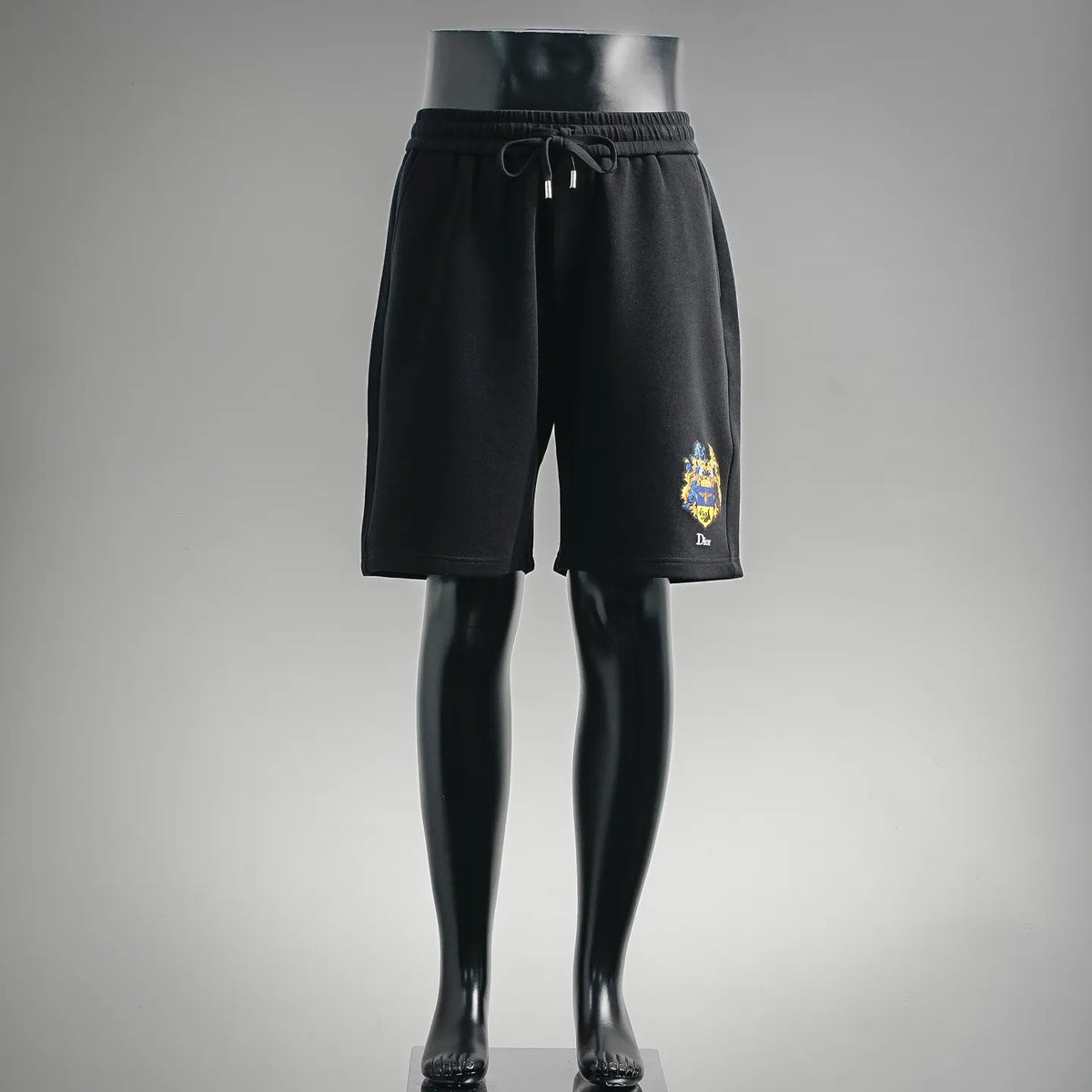 Dior black drawstring shorts with elastic waistband and small crest logo on leg