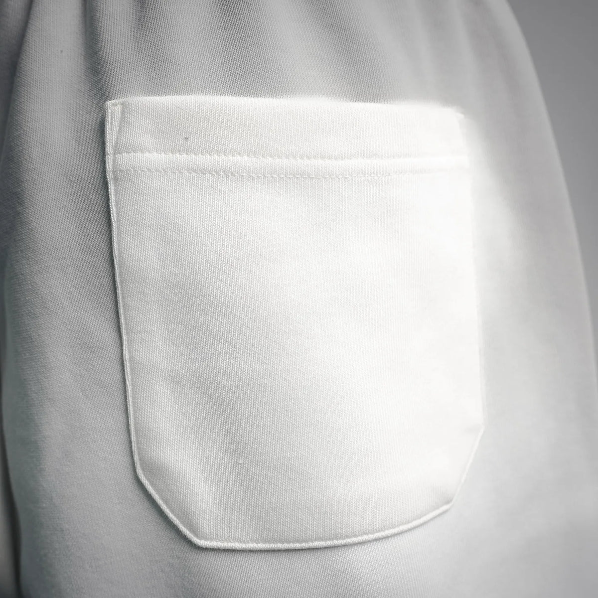 White shorts front with curved pocket opening