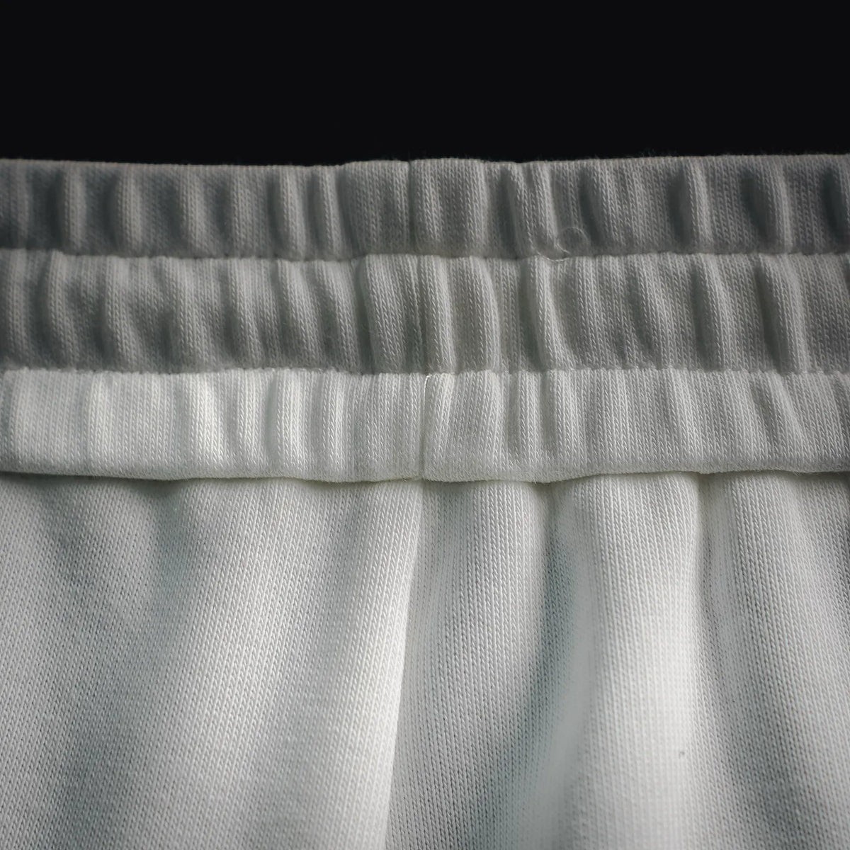 White elastic waistband with gathered fabric texture