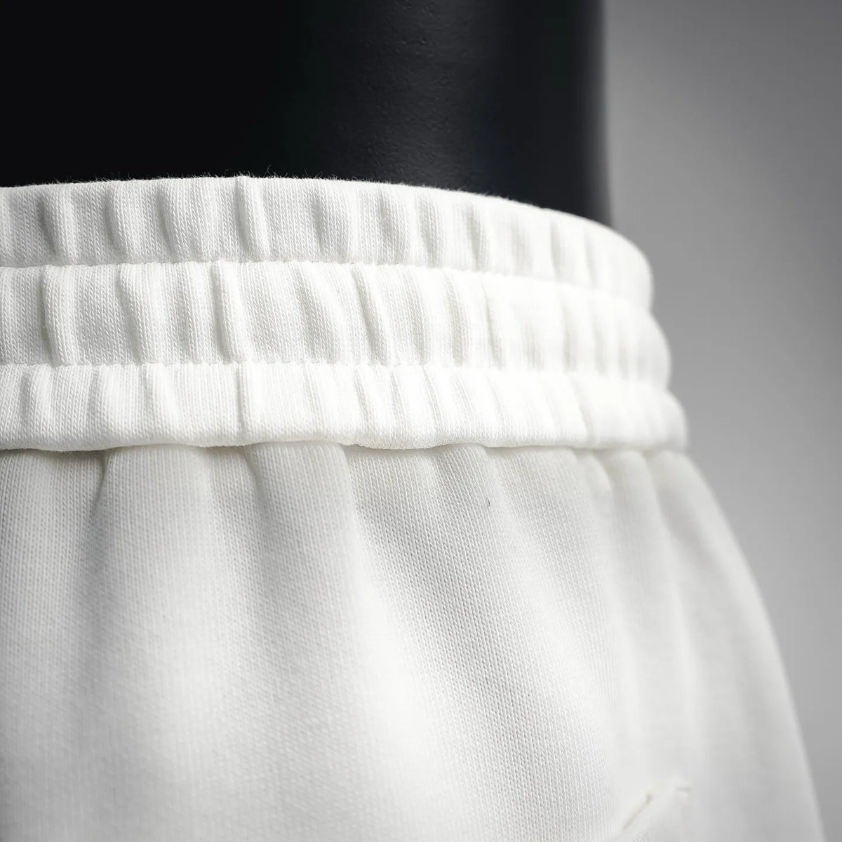 White elastic waistband with drawstring opening detail
