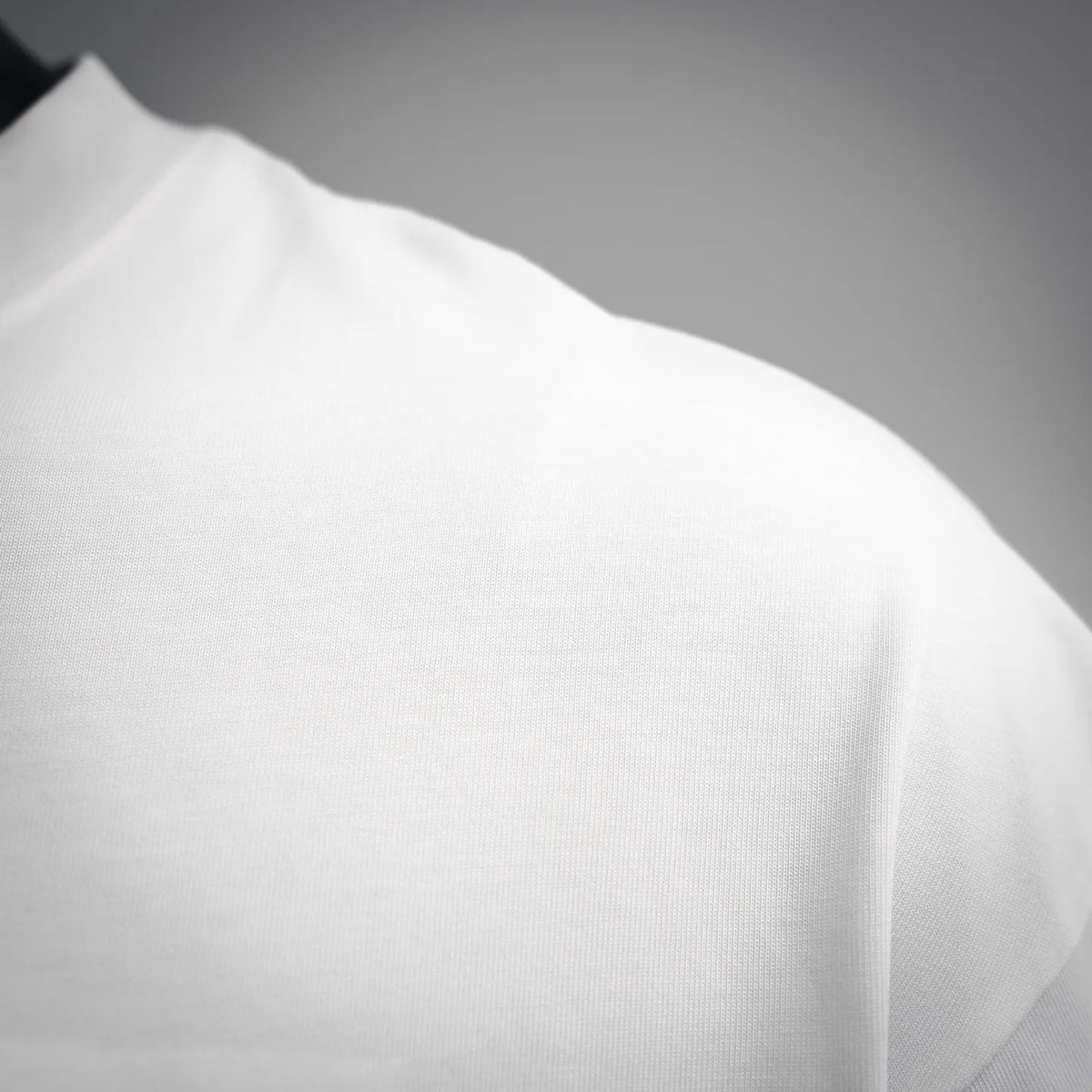 White crewneck T-shirt fabric close-up on shoulder and sleeve