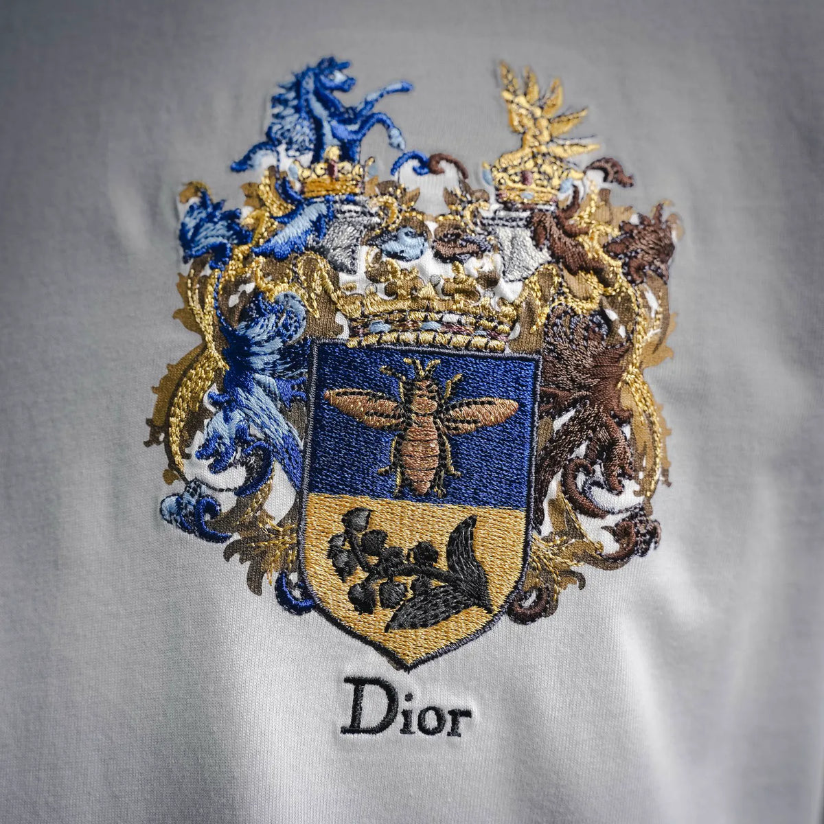 White crewneck T-shirt with large embroidered crest and Dior text below