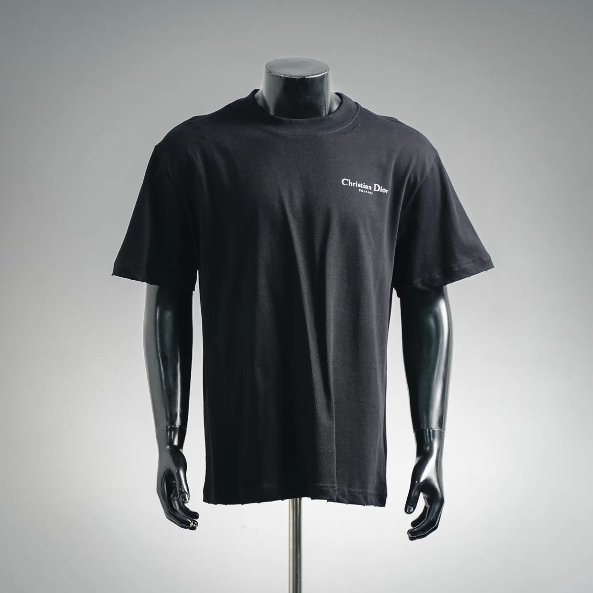 Black Dior short-sleeve T-shirt on a mannequin, small chest logo