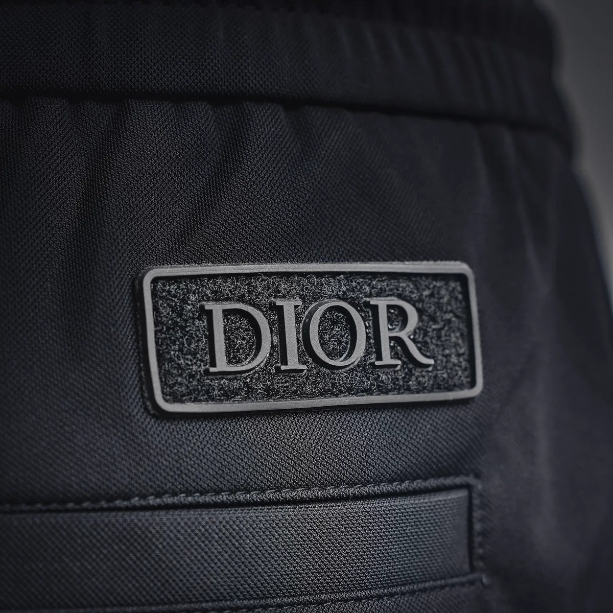 Dior black pants with DIOR logo patch on textured fabric
