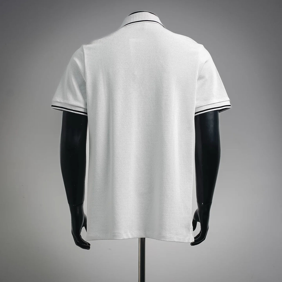 Dior white pique polo shirt, back view with black-trim cuffs