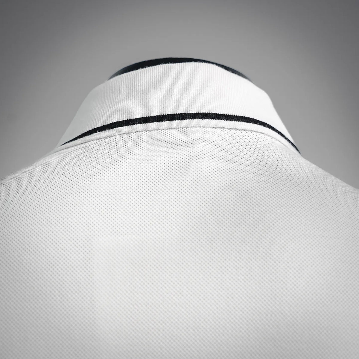 White polo collar with black striped trim