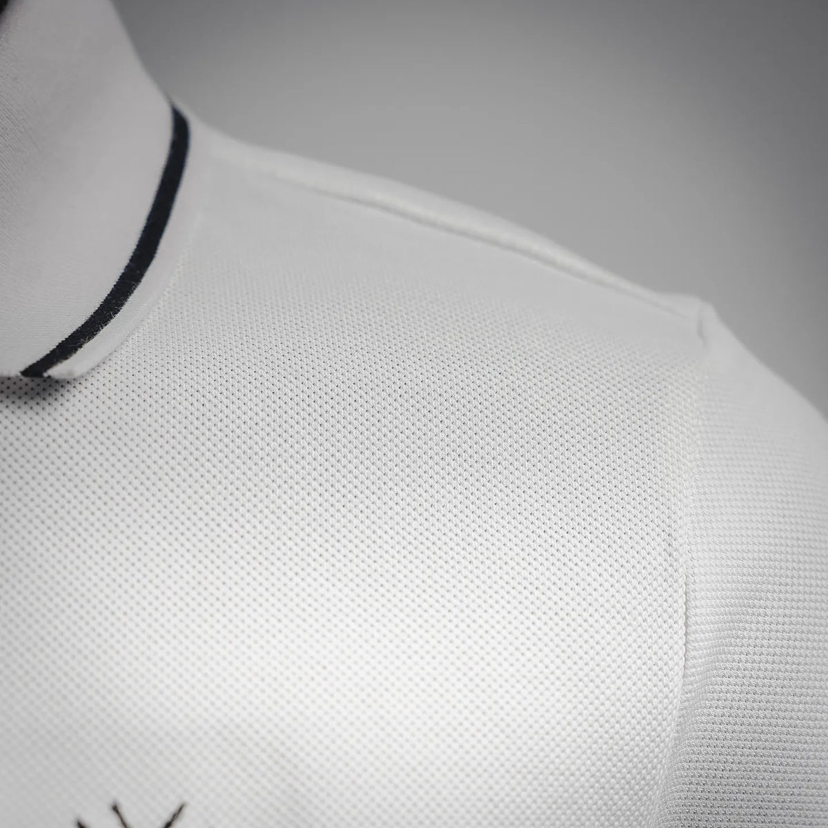 White polo shoulder and sleeve in textured pique knit
