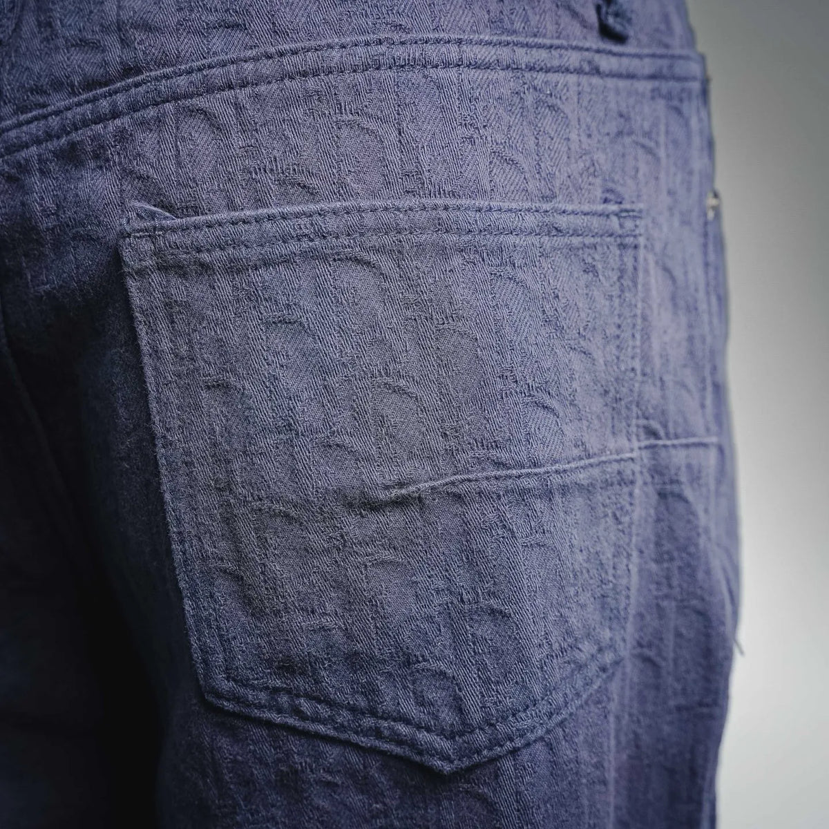 Dark blue Dior denim pants with front pocket and textured fabric